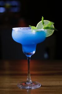 Boozi Babe Blue Cocktail in Margarita Glass with Lime Wedge